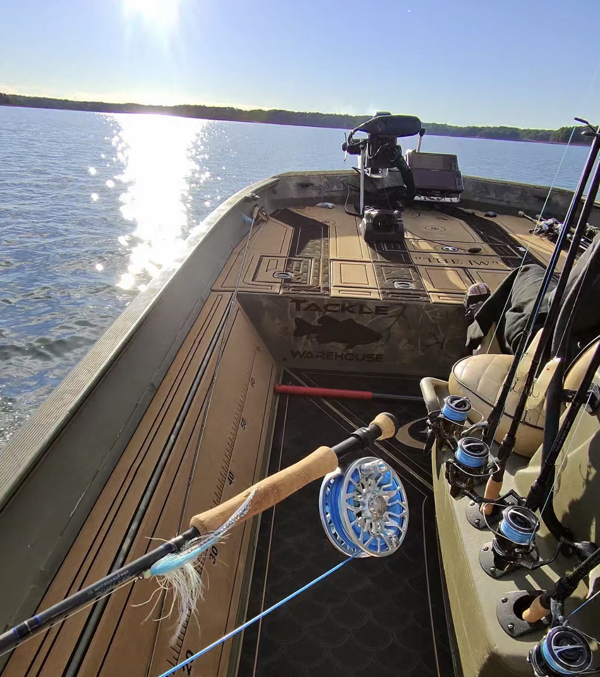 Fly fishing equipment aboard a bass boat on the lake